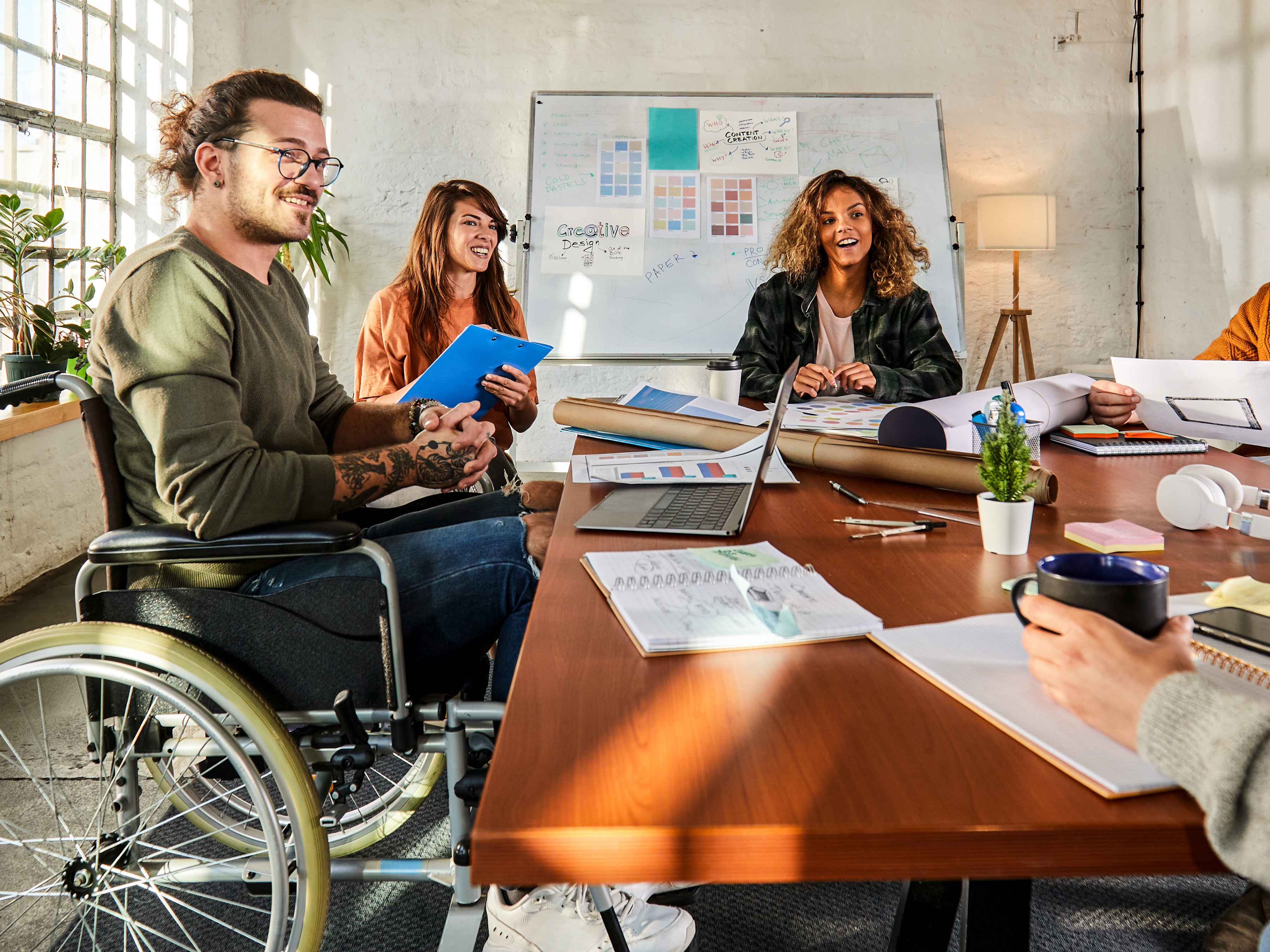 Office employees sitting together in a conference room. Office employees sitting together in a conference room.