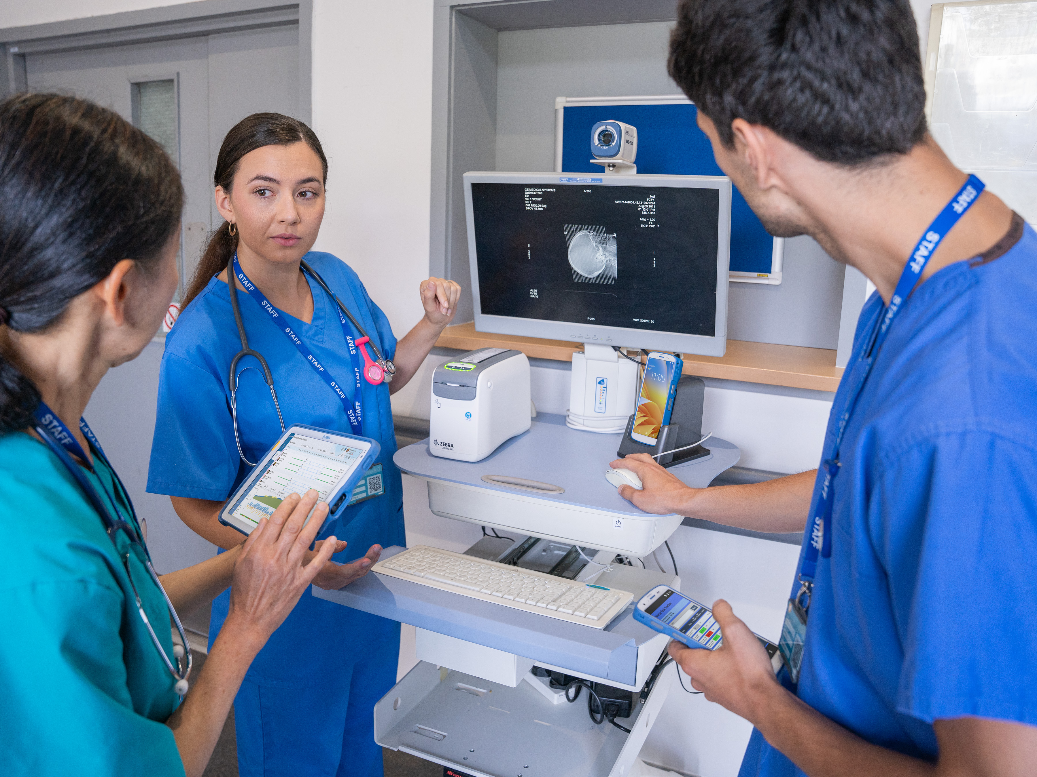 Clinicians look at patient images and records on a WOW and healthcare tablet