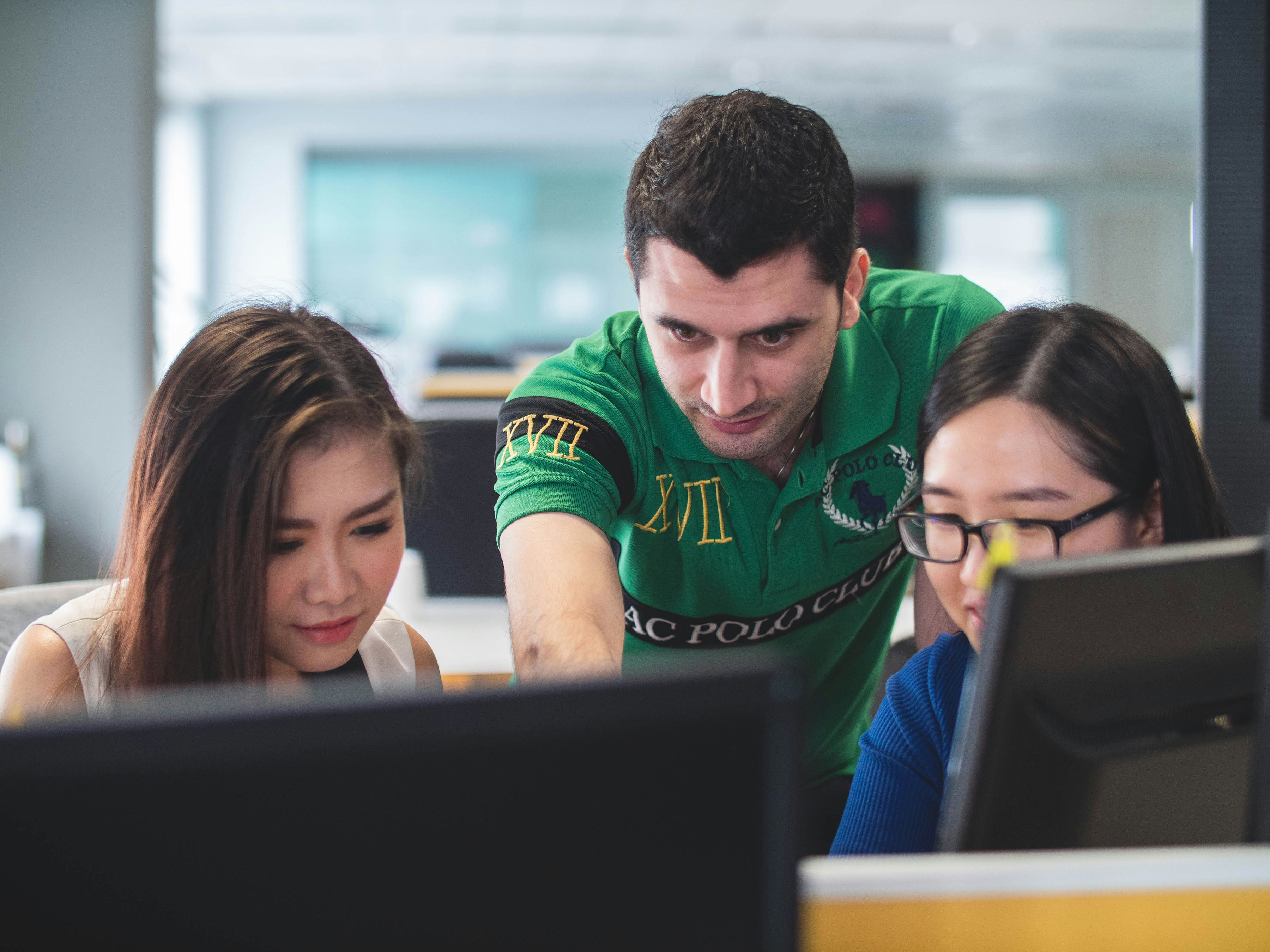 A group of people looking at a computer screen