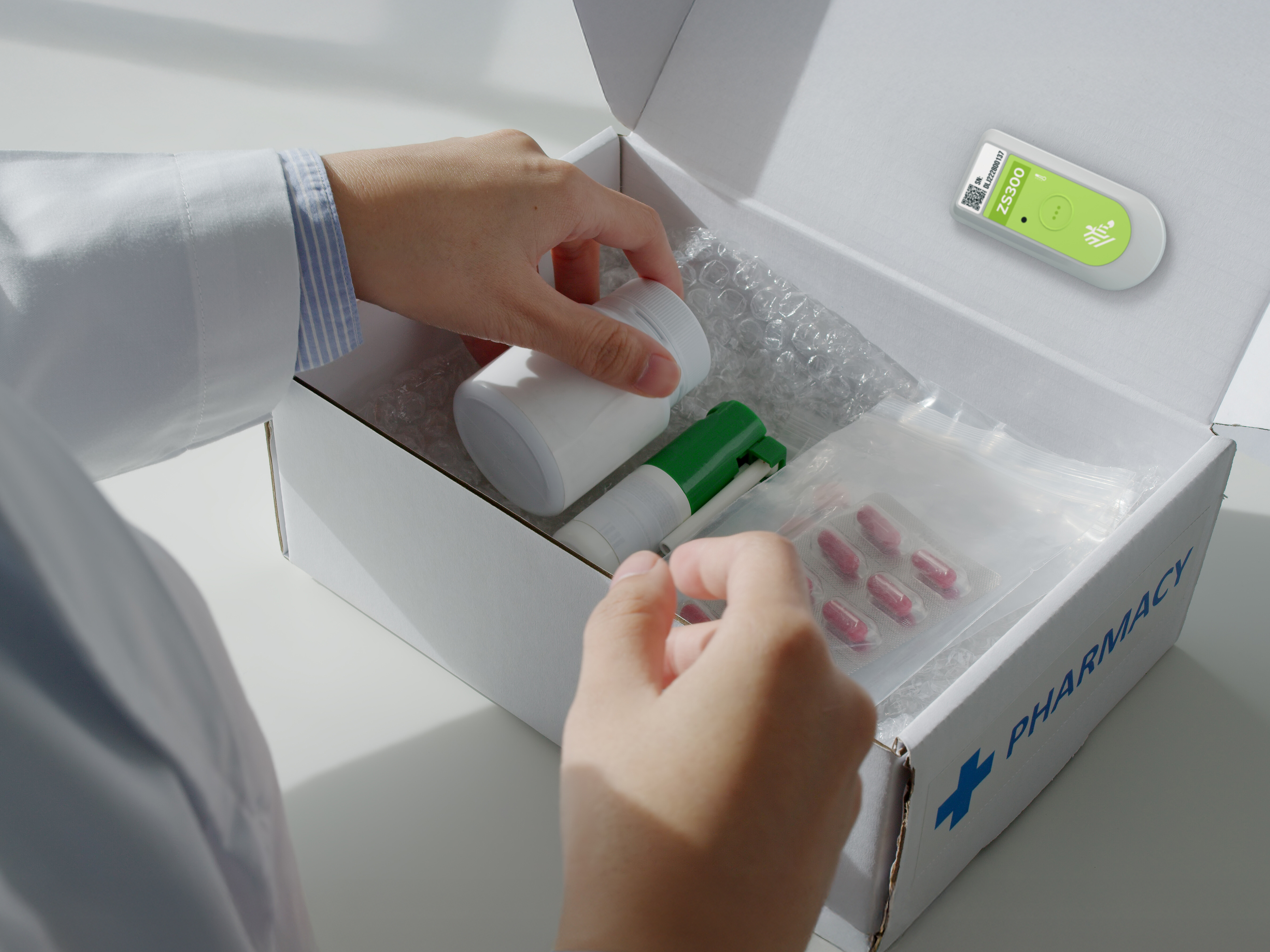 Pharmacy products being packed in a box with a Zebra ZS300 Pharmacy products being packed in a box with a Zebra ZS300