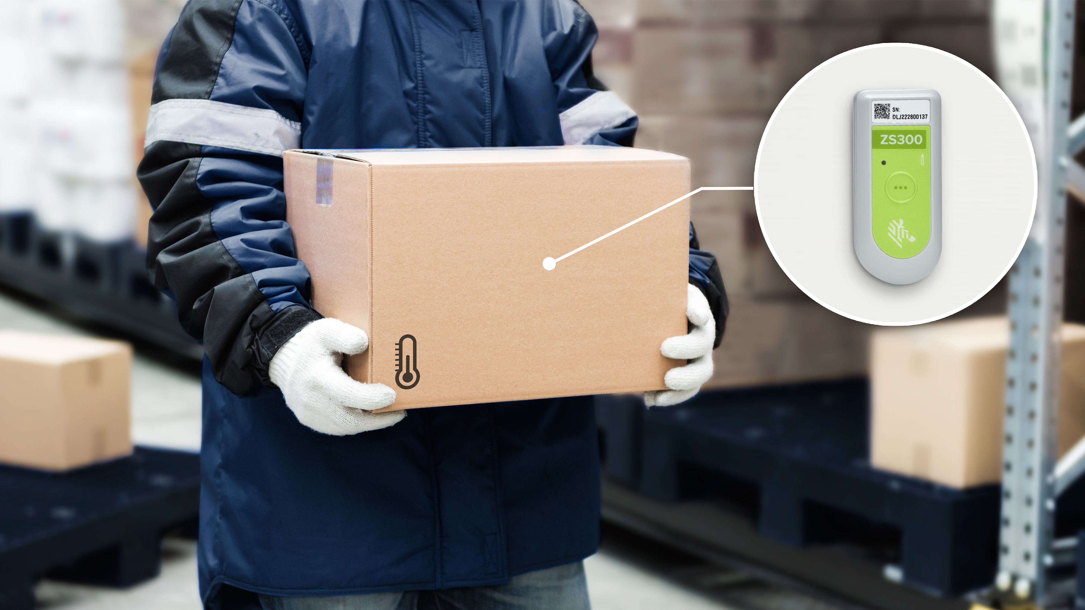A temperature monitored package being held by a warehouse worker A temperature monitored package being held by a warehouse worker