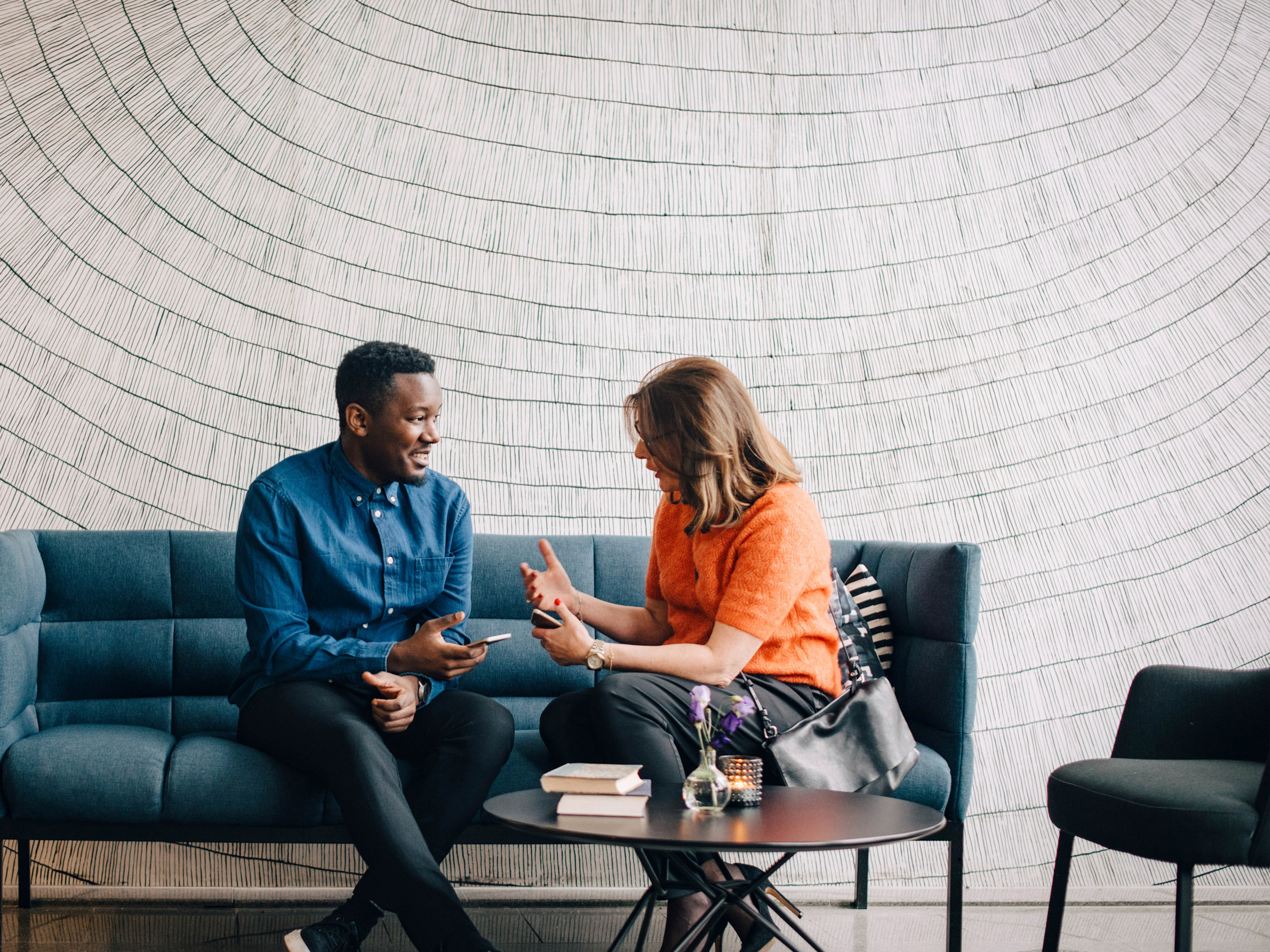 Two coworkers speaking in a modern office. Two coworkers speaking in a modern office.
