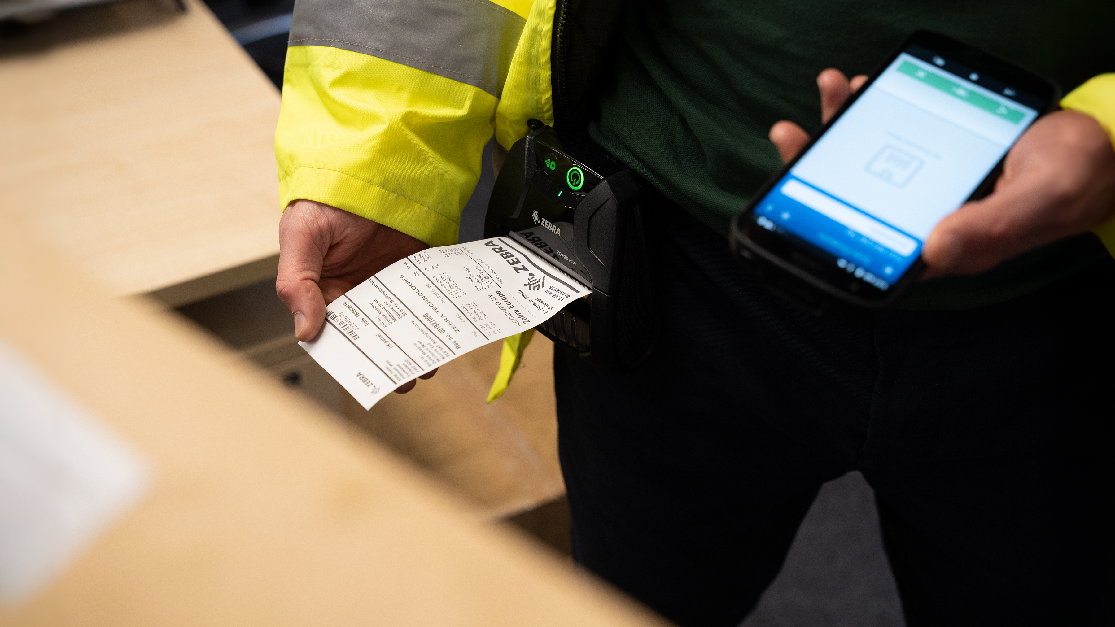 Field operations worker printers a label on a Zebra mobile printer. Field operations worker printers a label on a Zebra mobile printer.