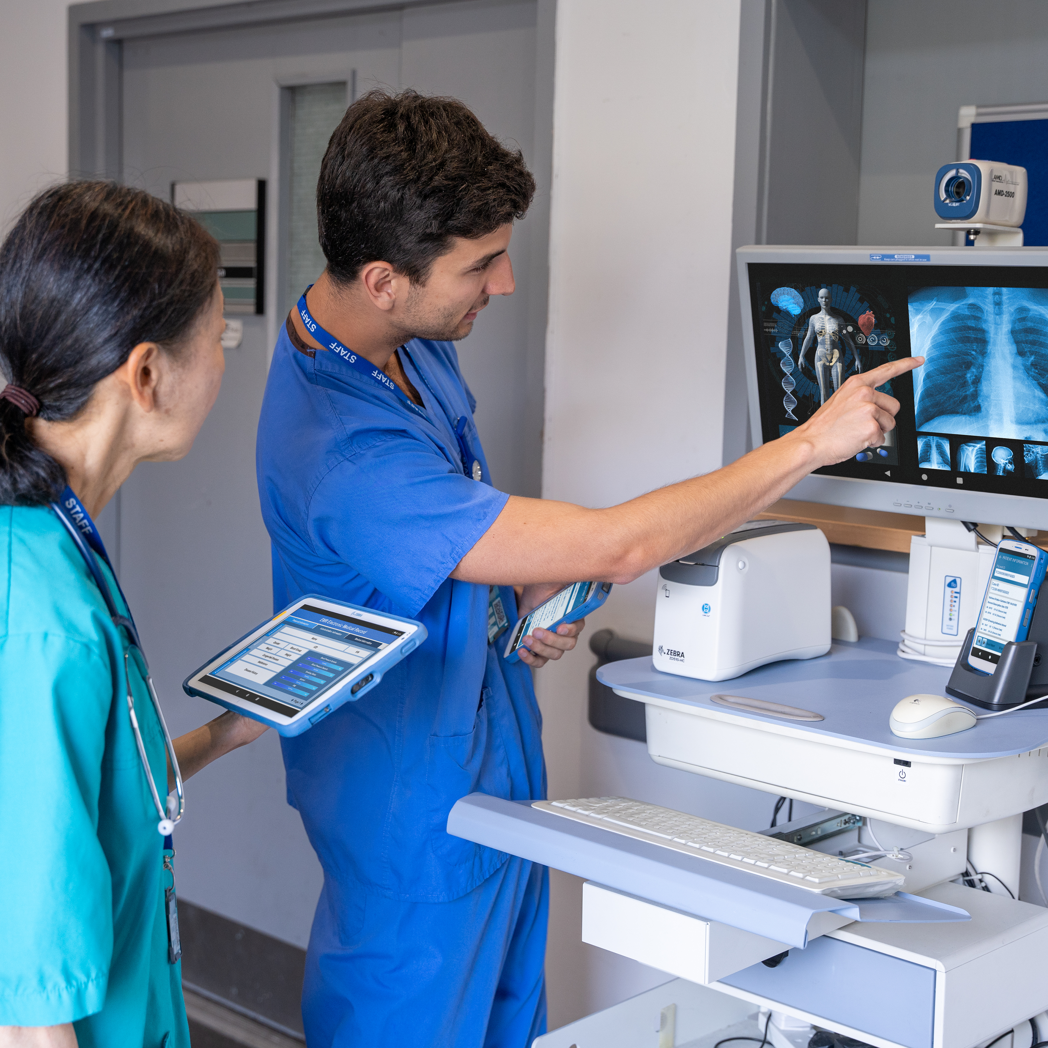 healthcare-photography-website-hc50-et4x-hc-zd510-hc-connect-cradle-hallway-doctor-nurse-viewing-patient-record-16x9-3600x3600 healthcare-photography-website-hc50-et4x-hc-zd510-hc-connect-cradle-hallway-doctor-nurse-viewing-patient-record-16x9-3600x3600