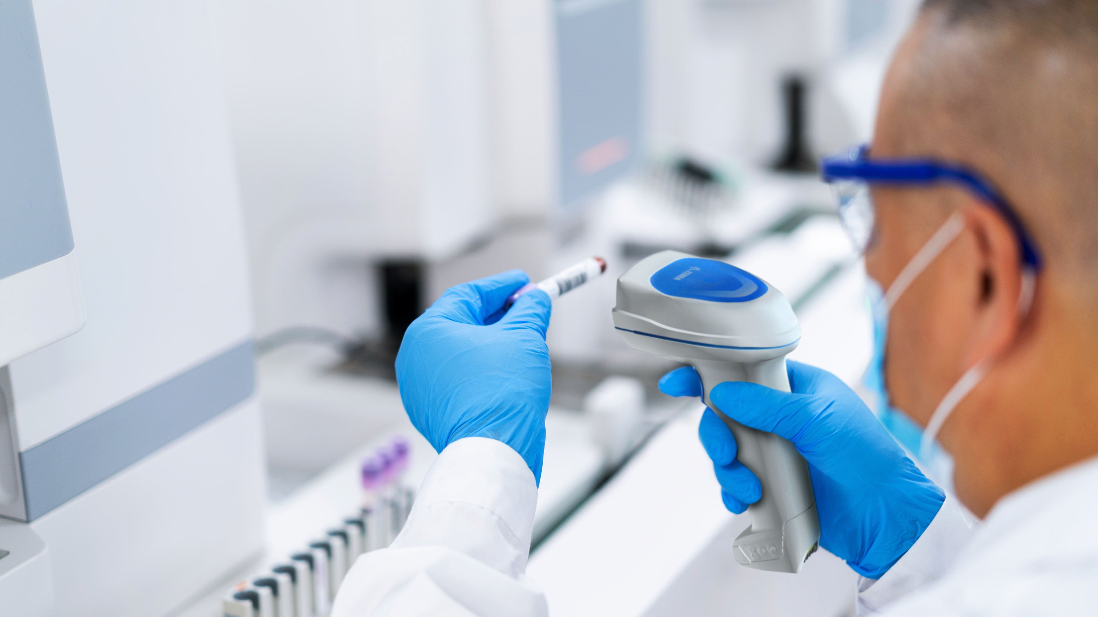 Lab worker using a Zebra handheld scanner to process a specimen. Lab worker using a Zebra handheld scanner to process a specimen.
