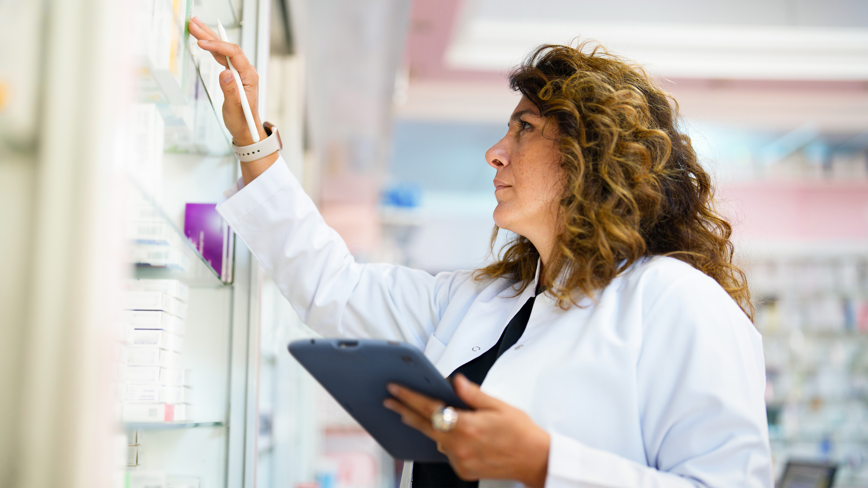 Pharmacist managing inventory with a Zebra tablet. Pharmacist managing inventory with a Zebra tablet.