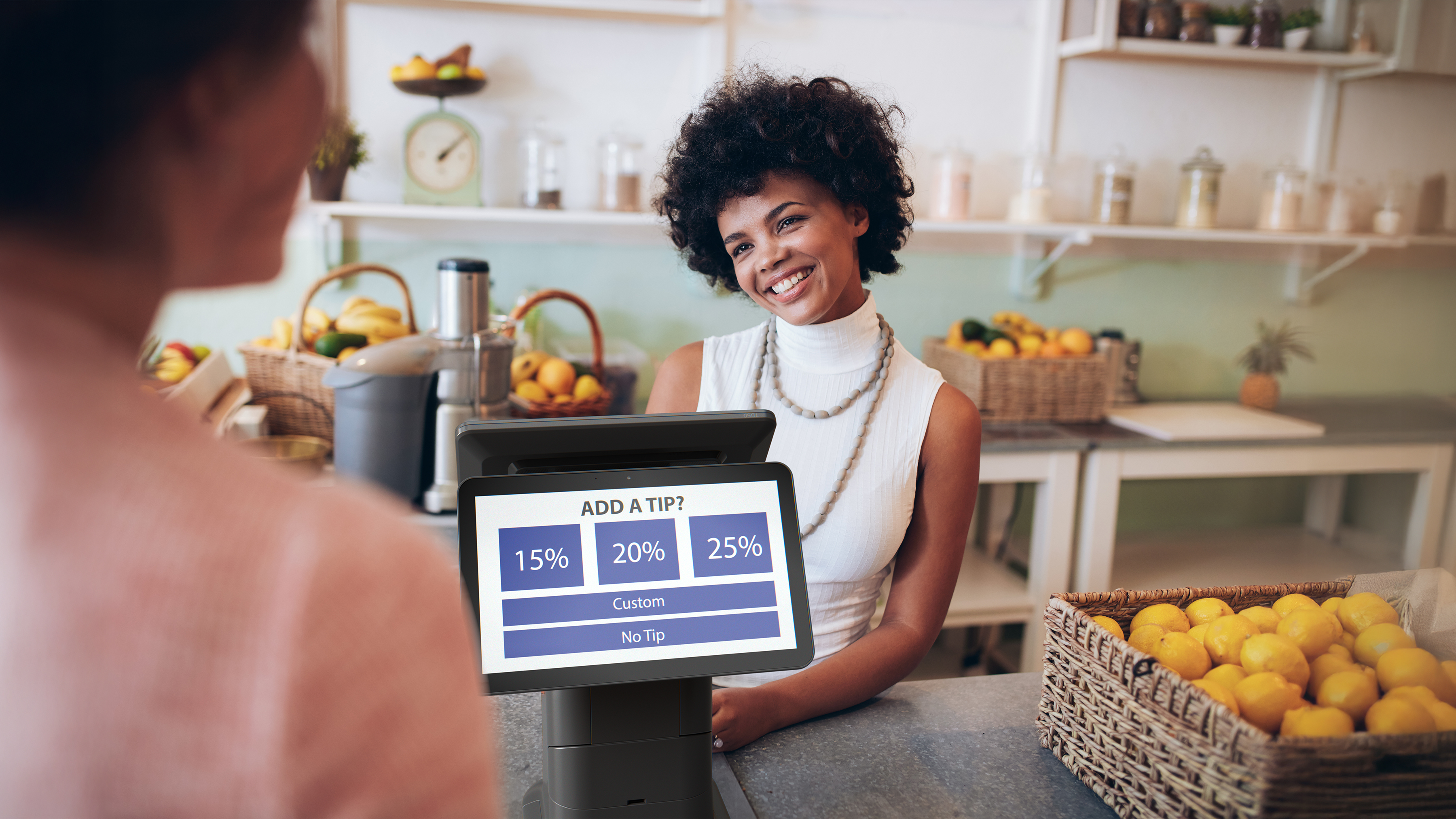 Cashier using a Zebra Interactive Kiosk to process a sale in a restaurant. Cashier using a Zebra Interactive Kiosk to process a sale in a restaurant.