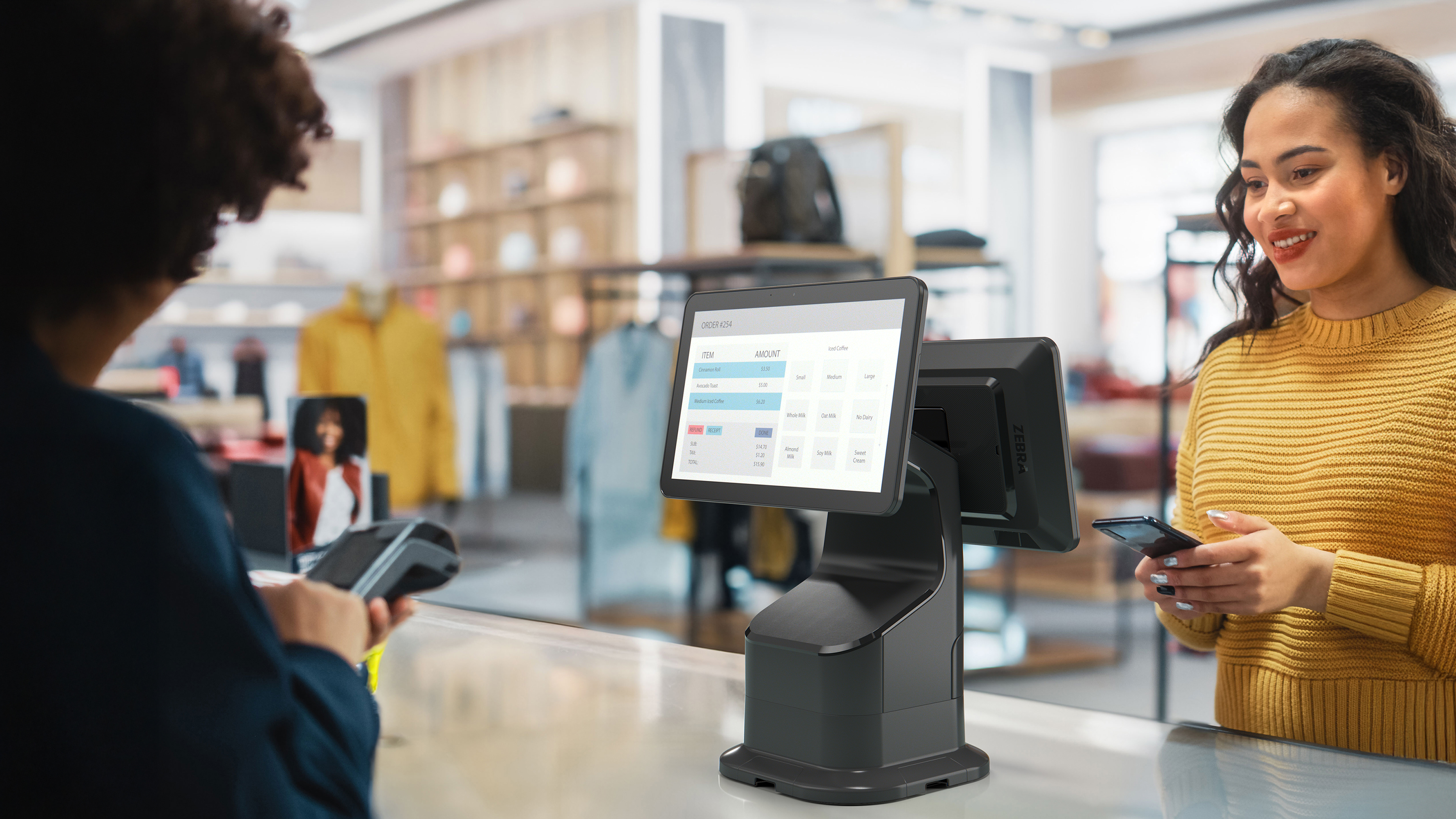 Retail cashier processing a purchase on a Zebra Interactive Kiosk.  Retail cashier processing a purchase on a Zebra Interactive Kiosk.