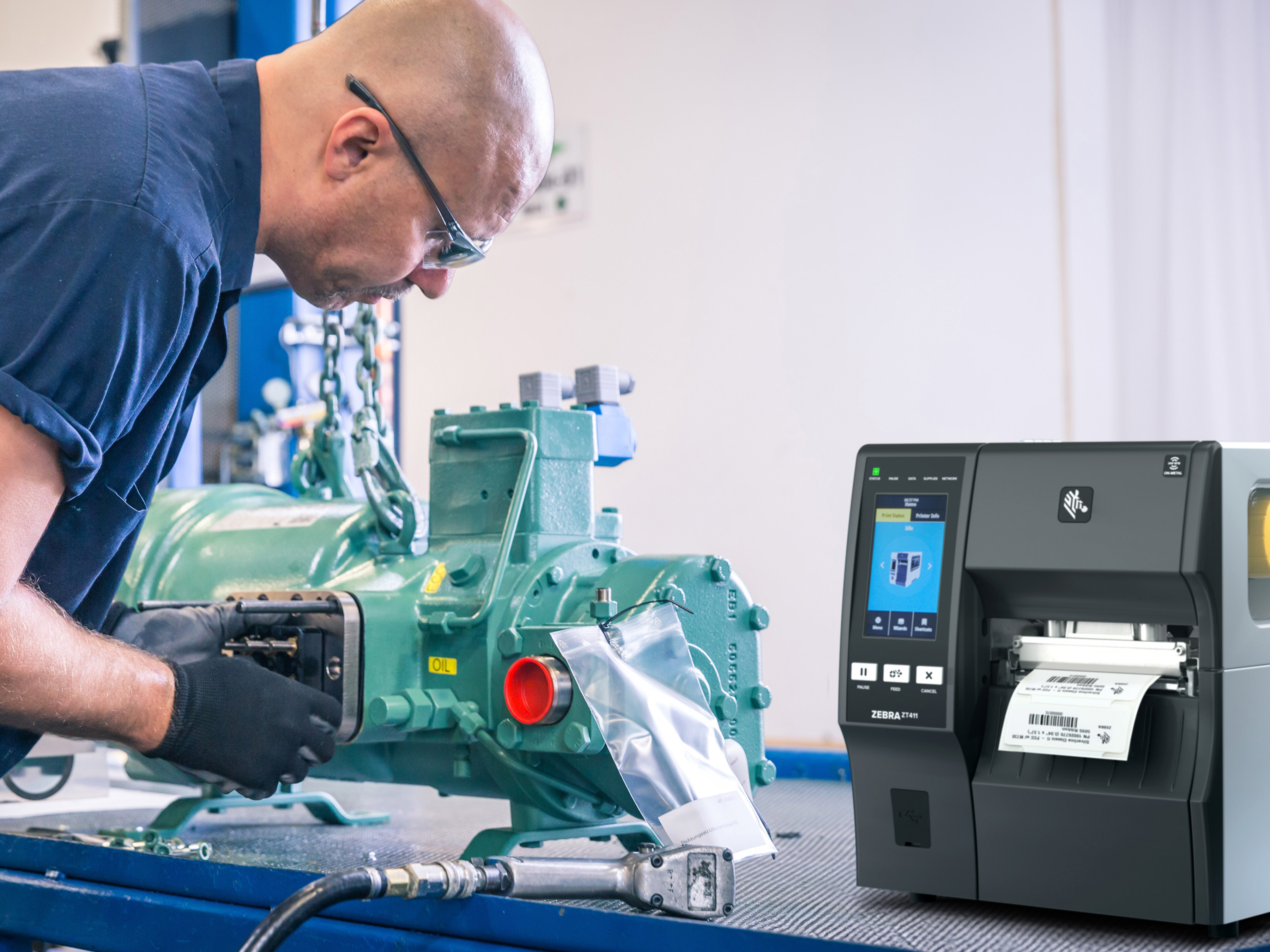 Worker using a Zebra industrial printer in a manufacturing setting.  Worker using a Zebra industrial printer in a manufacturing setting.