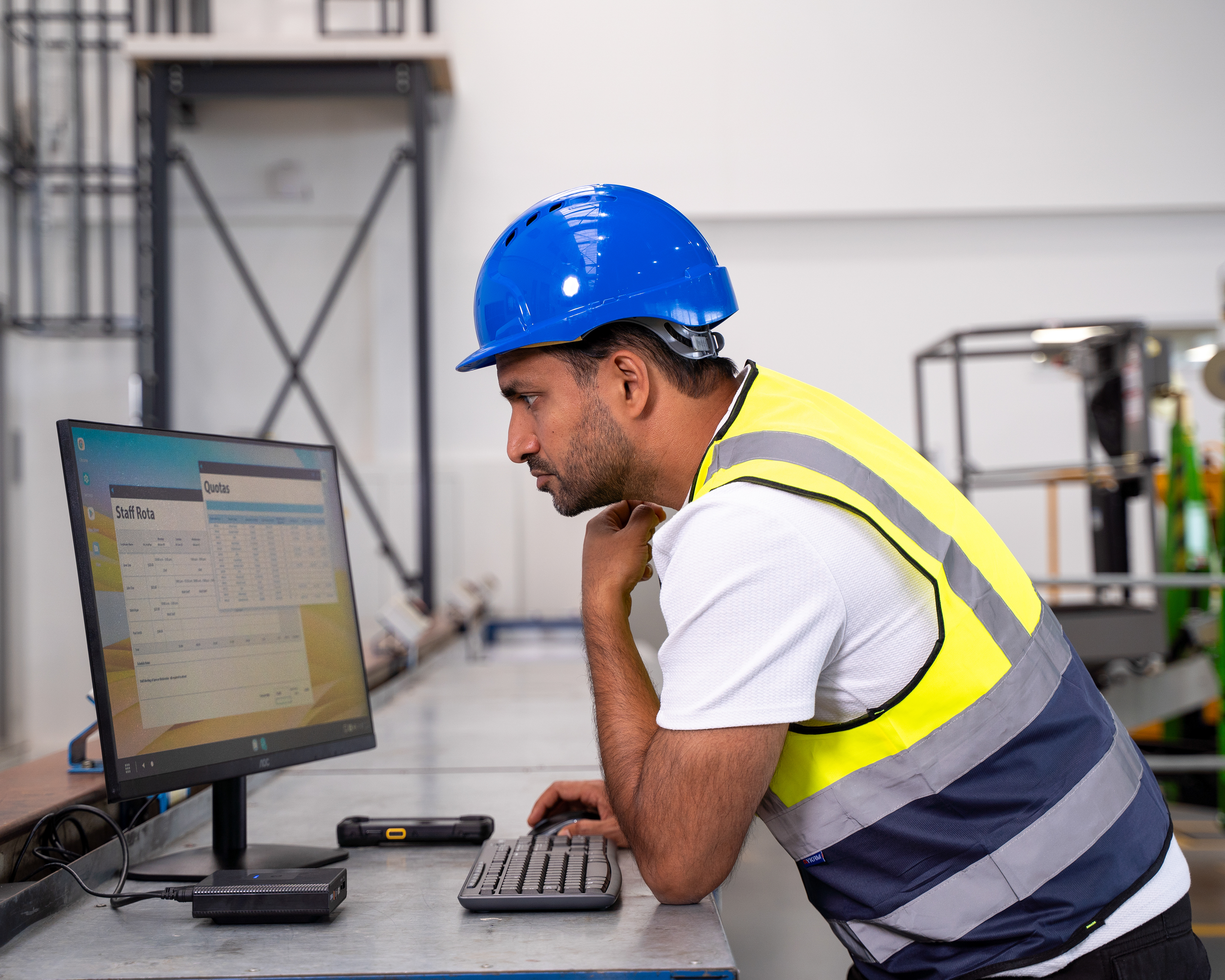 ZEC500 Photography Website Manufacturing Wireless Workstation Connect- TC73 5x4 Manufacturing worker using ZEC500 with Workstation Connect and TC73 to review dashboards on digital display.