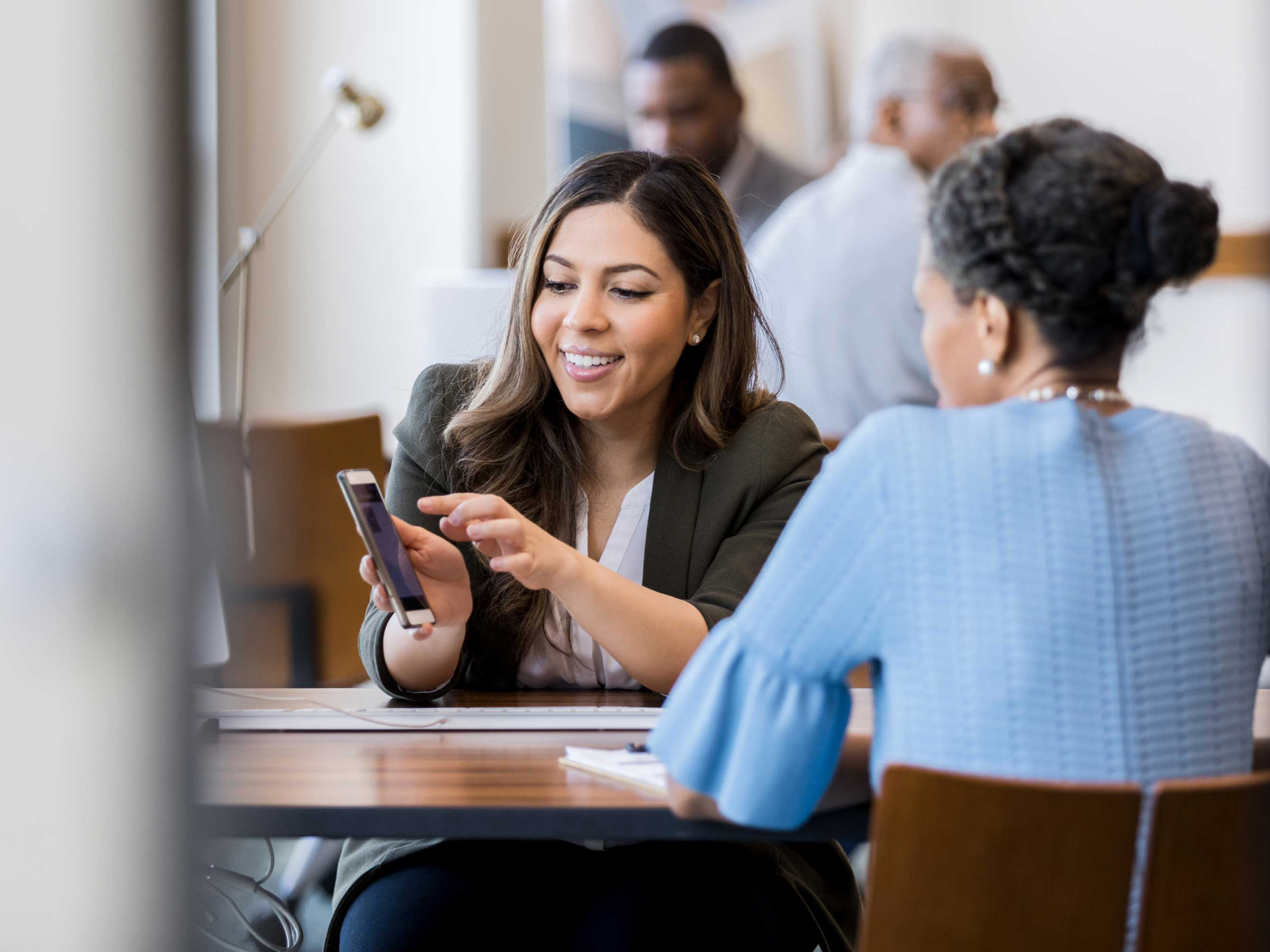 Two women having a discussion in a meeting Two women having a discussion in a meeting