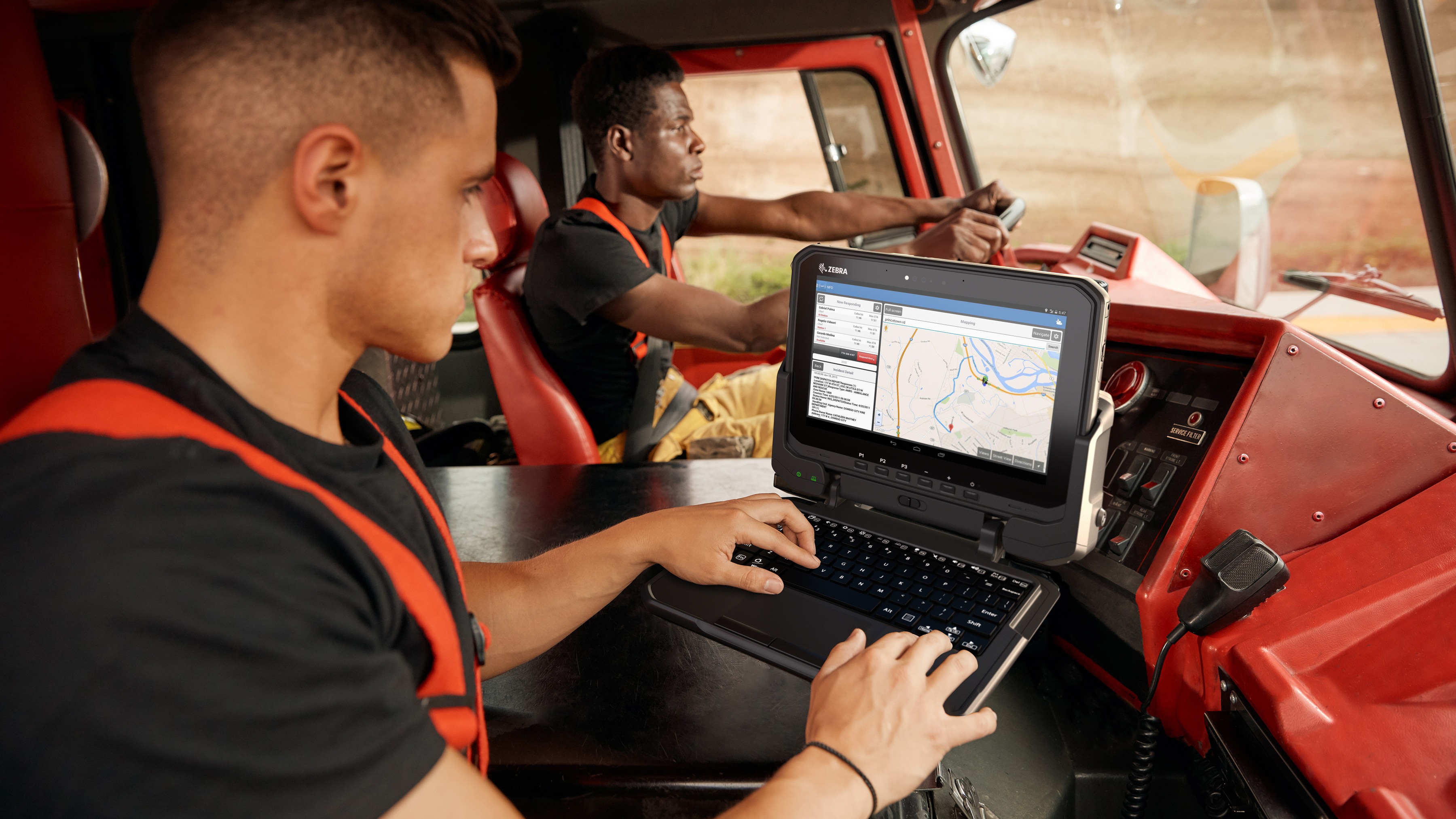 Firefighters using Zebra tablet in a fire truck. Firefighters using Zebra tablet in a fire truck.