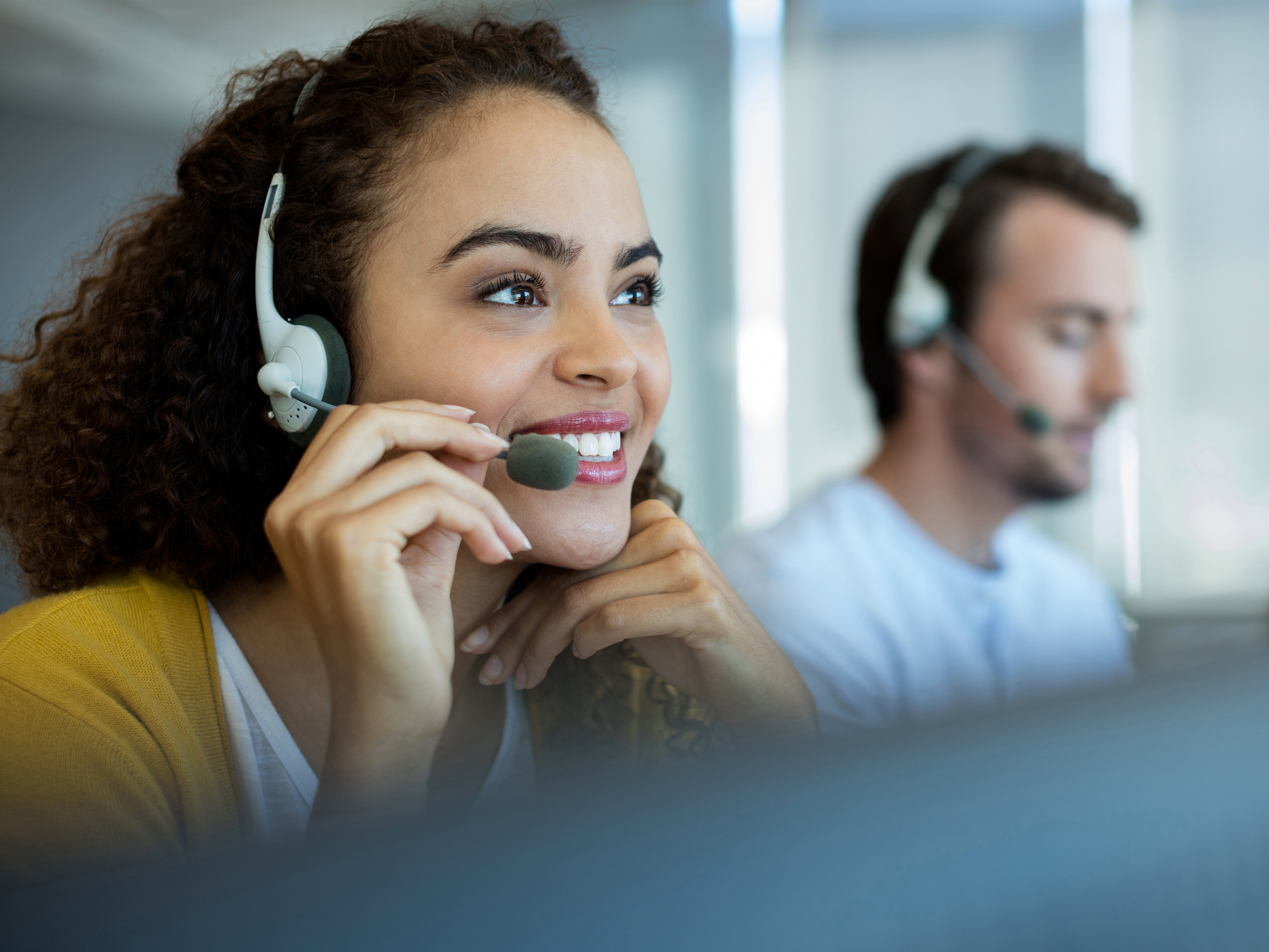 Customer support agents at work using a headset with microphone Customer support agents at work using a headset with microphone
