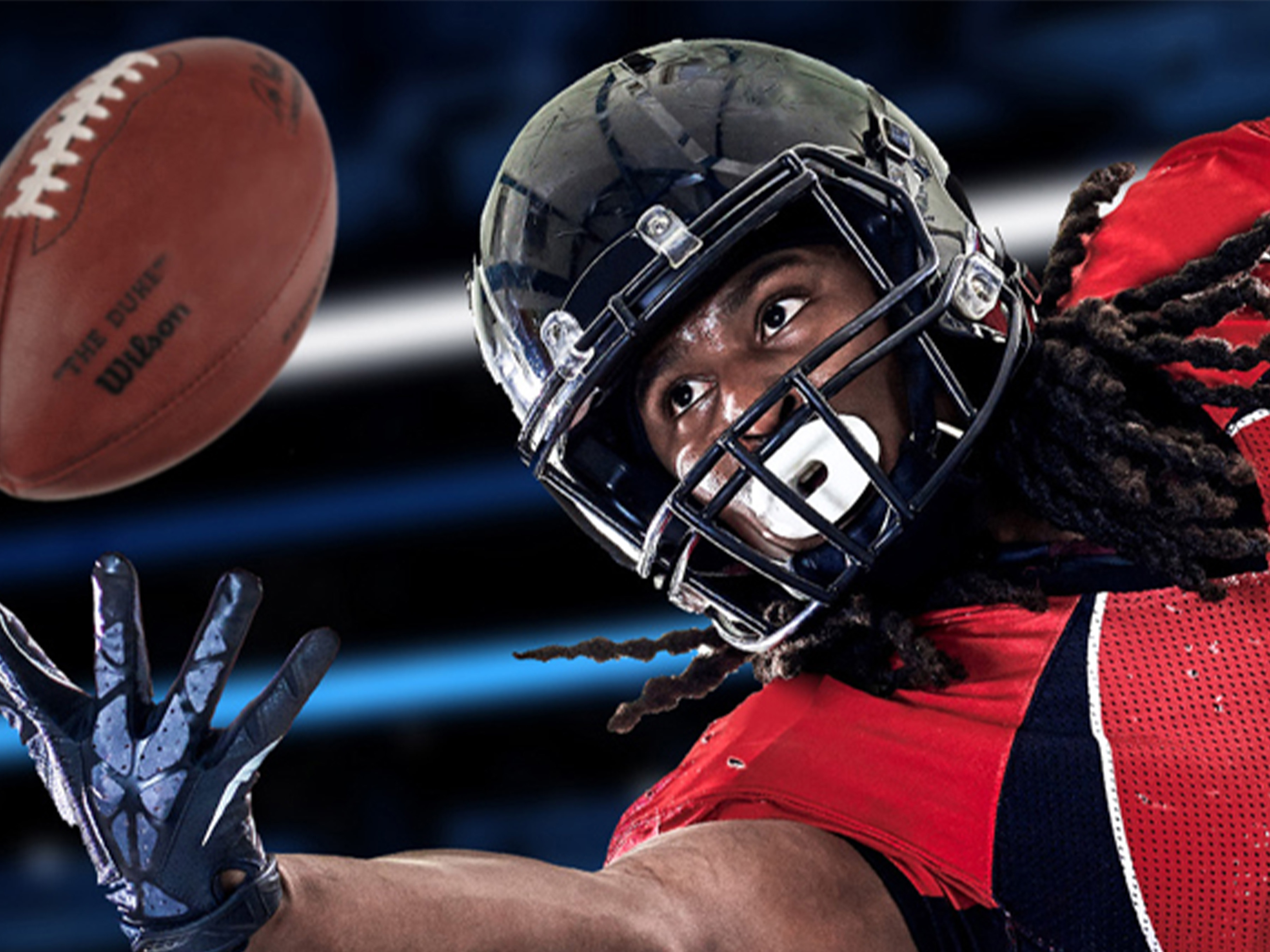 Football player reaching for the ball.  Football player reaching for the ball.