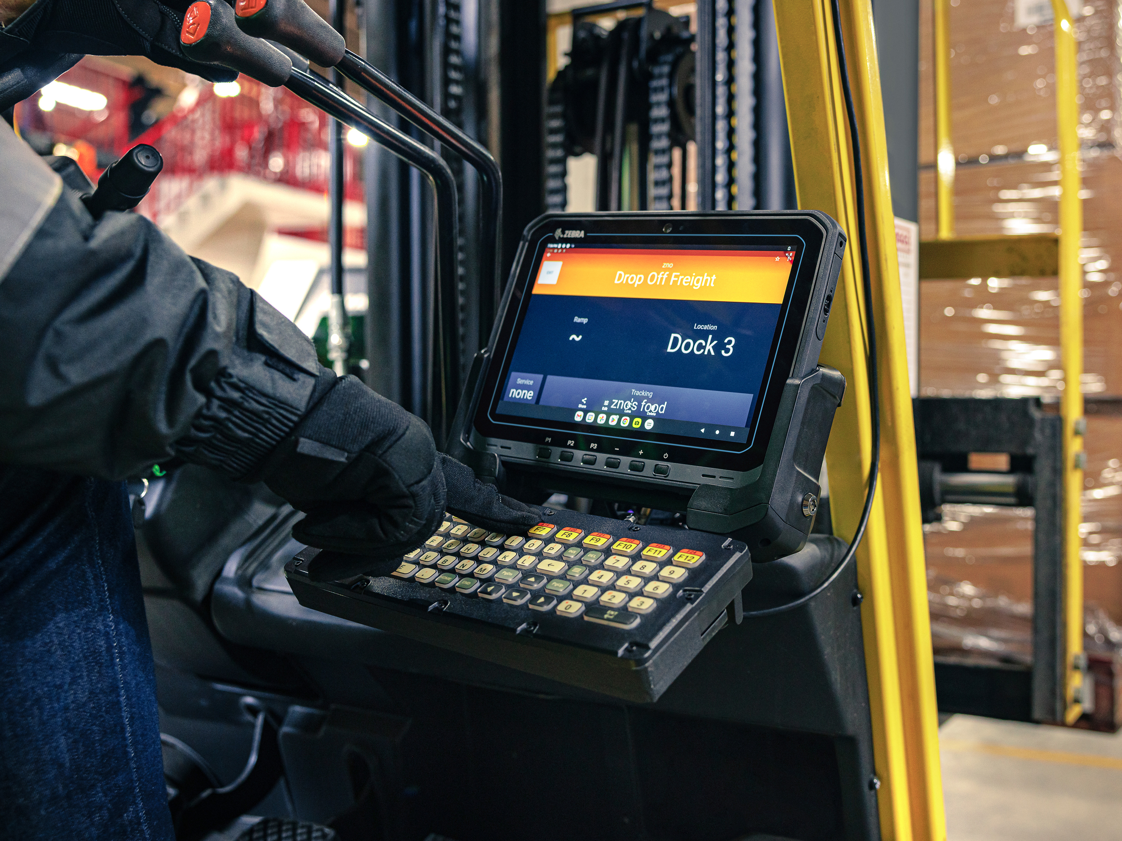 Forklift operator using a Zebra mounted tablet in a warehouse. Forklift operator using a Zebra mounted tablet in a warehouse.