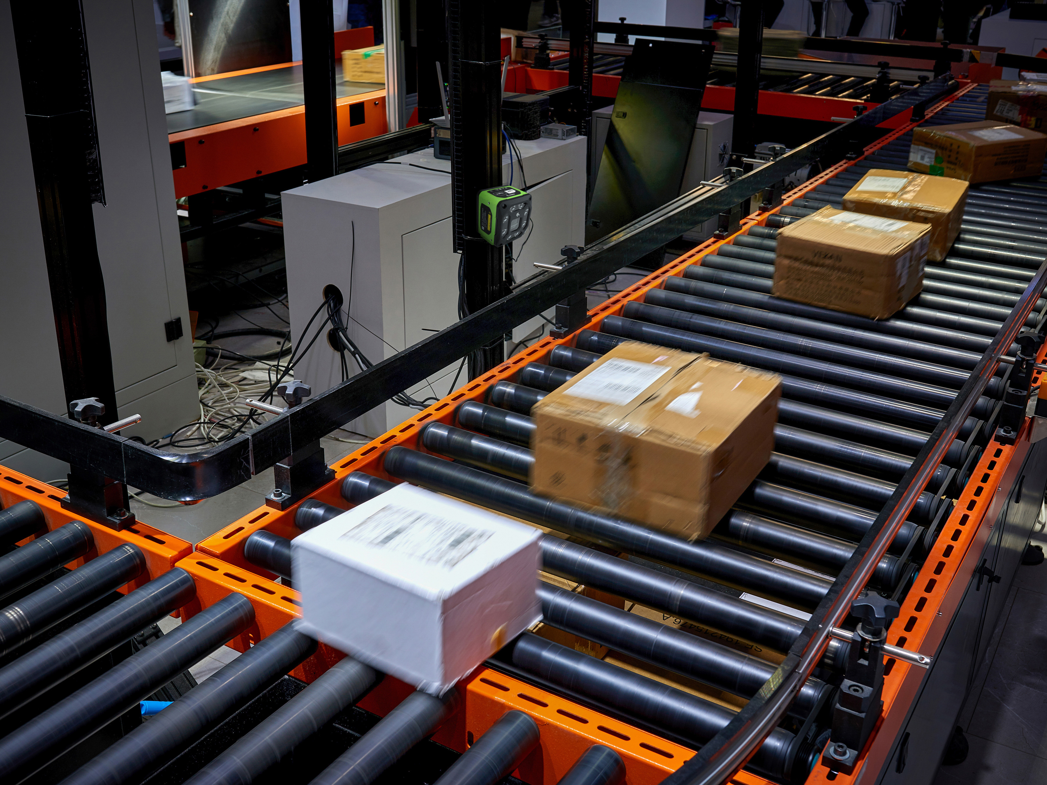 Parcels being sorted at the warehouse by a Zebra fixed scanner  Parcels being sorted at the warehouse by a Zebra fixed scanner