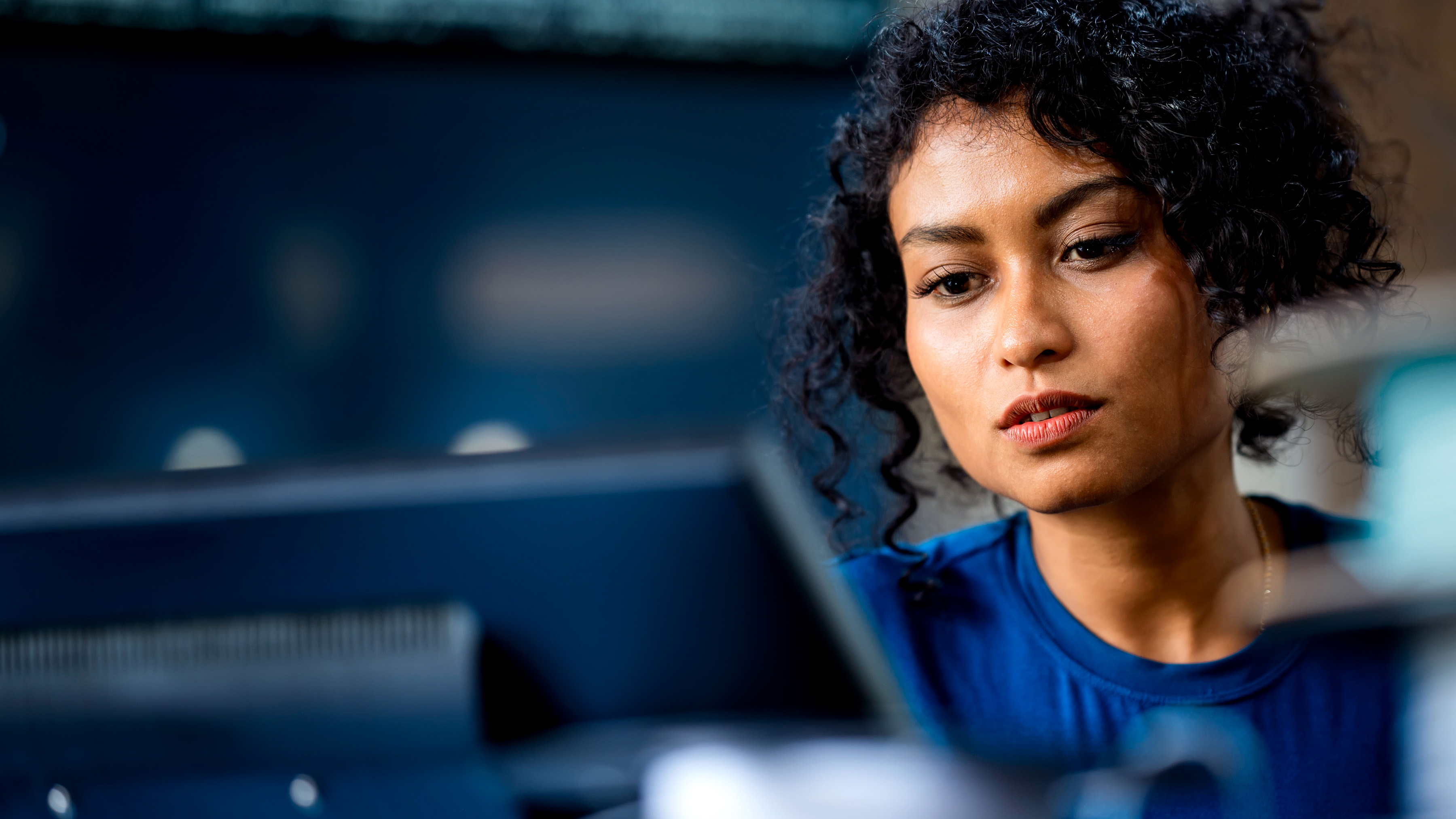 A person looking at a computer workstation. A person looking at a computer workstation.