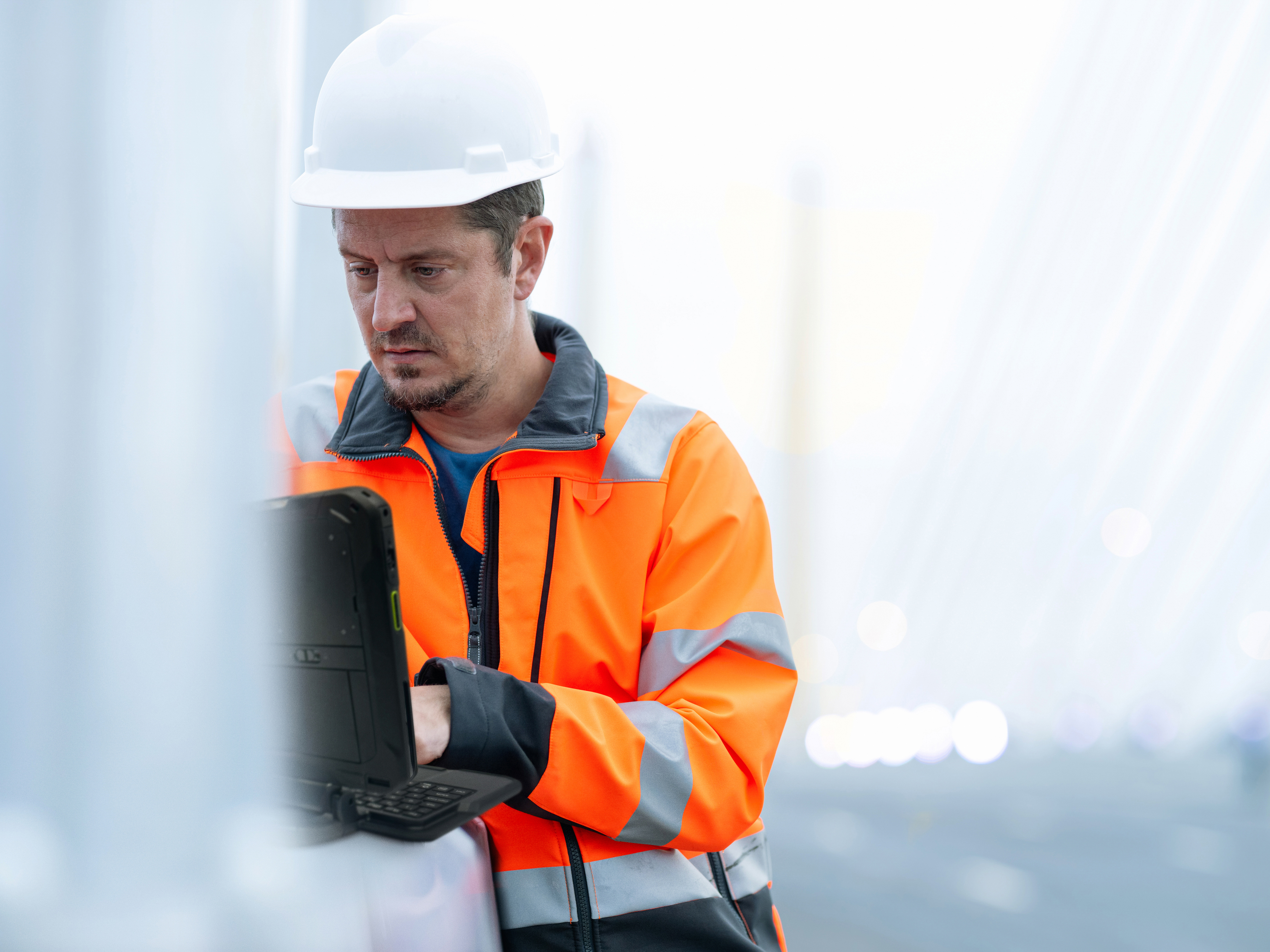 A field operations engineer using a rugged tablet. A field operations engineer using a rugged tablet.
