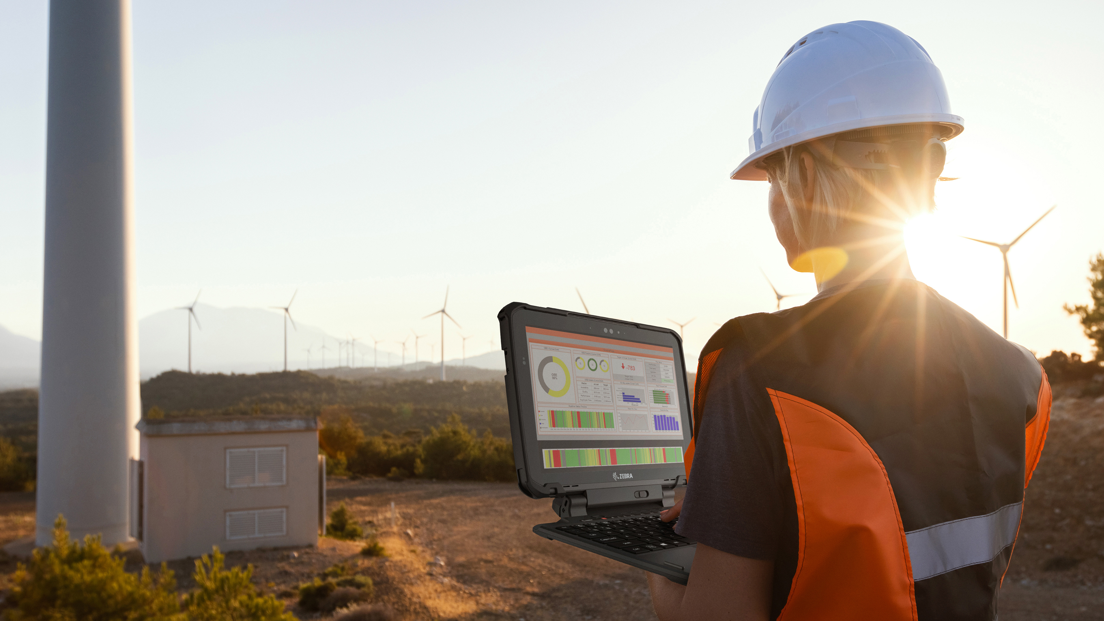 An engineer using a laptop during a wind power field inspection. An engineer using a laptop during a wind power field inspection.