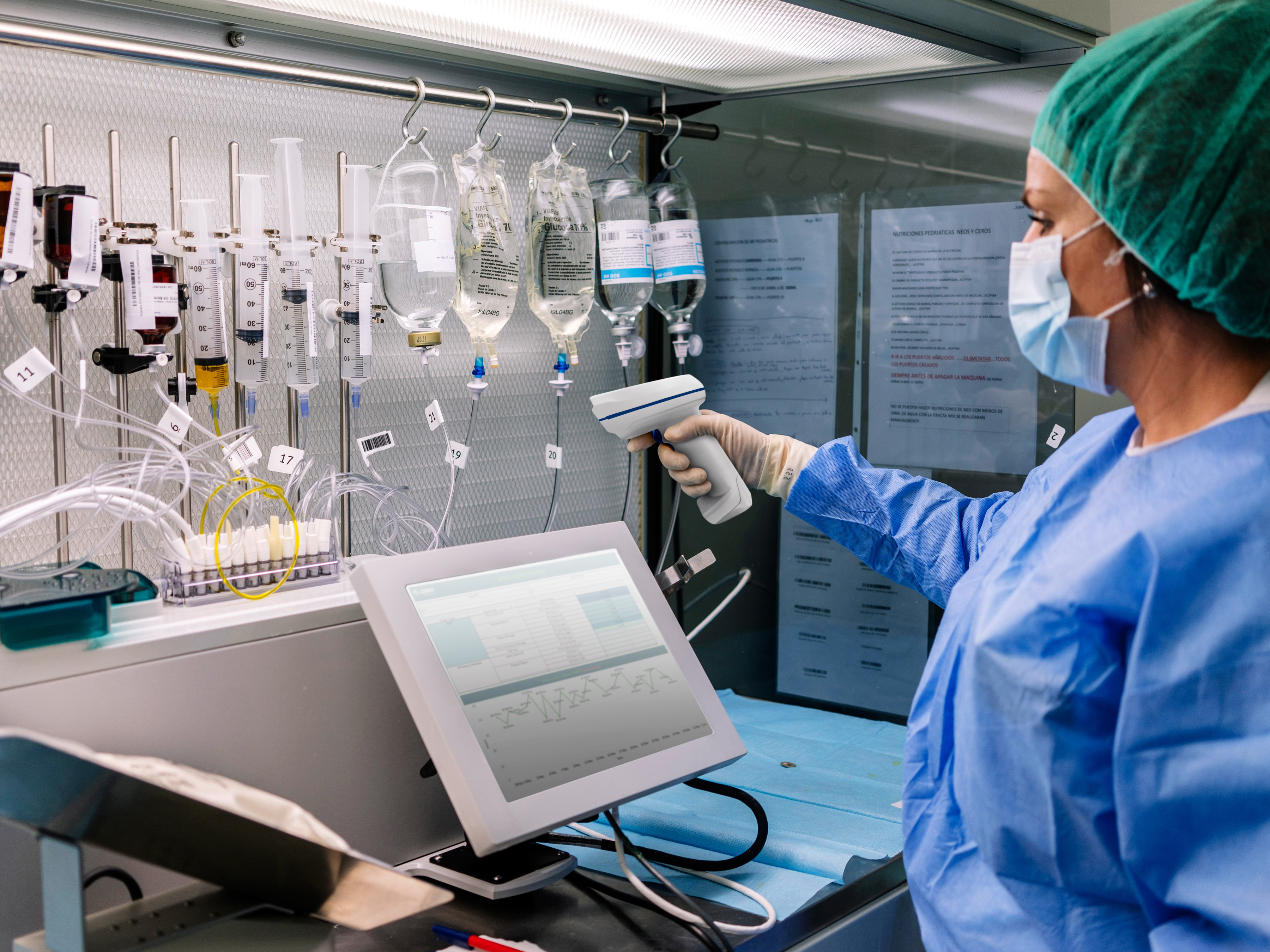 Healthcare workers using a Zebra healthcare barcode scanner to scan IV drips in a laboratory workstation. Healthcare workers using a Zebra healthcare barcode scanner to scan IV drips in a laboratory workstation.