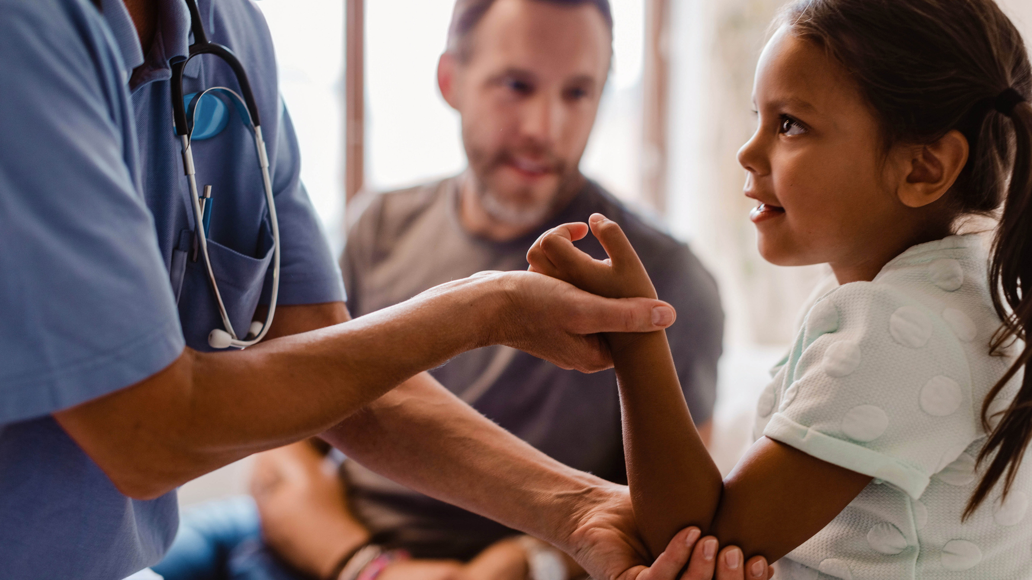 A child patient getting checked by a medical professional. A child patient getting checked by a medical professional.