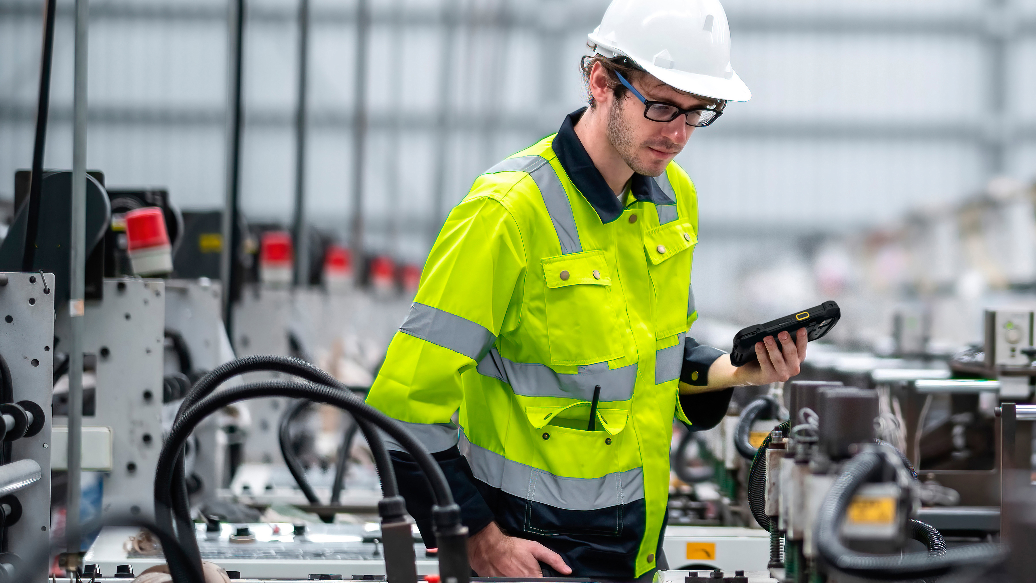 Engineer holding a tablet inspecting a production line. . Engineer holding a tablet inspecting a production line.