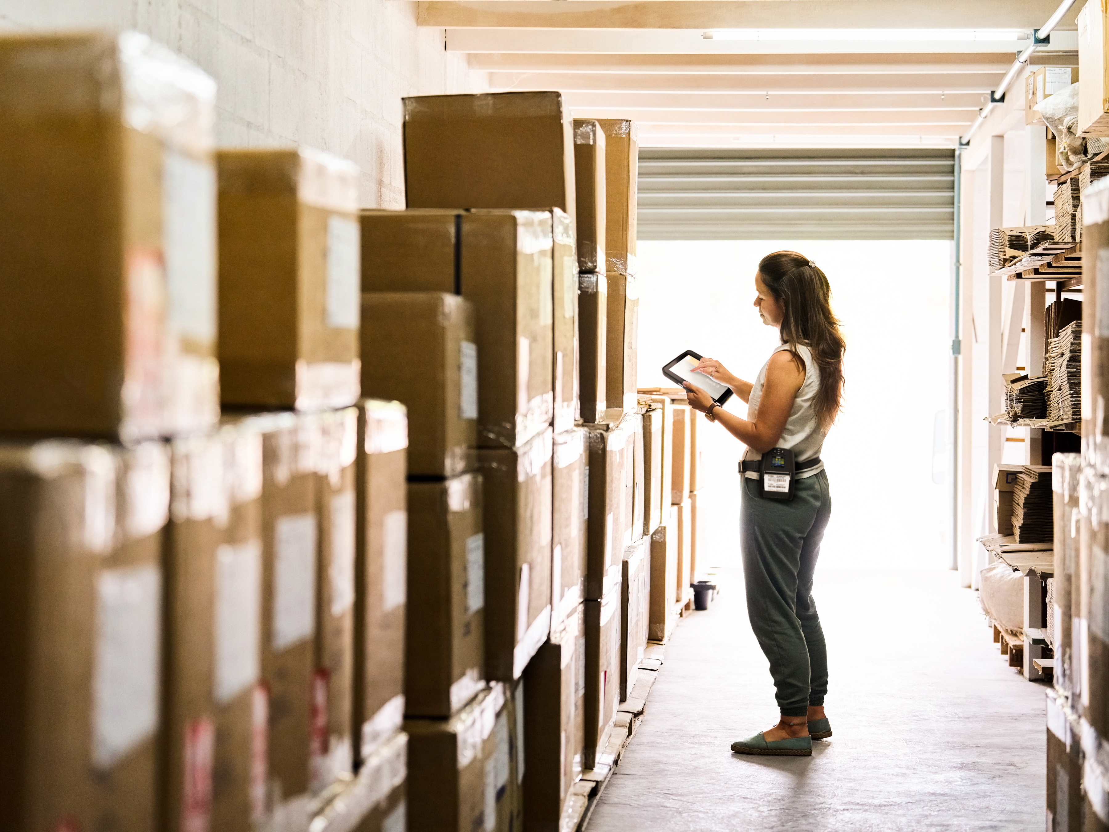 An employee handling box deliveries using a Zebra tablet.  An employee handling box deliveries using a Zebra tablet.