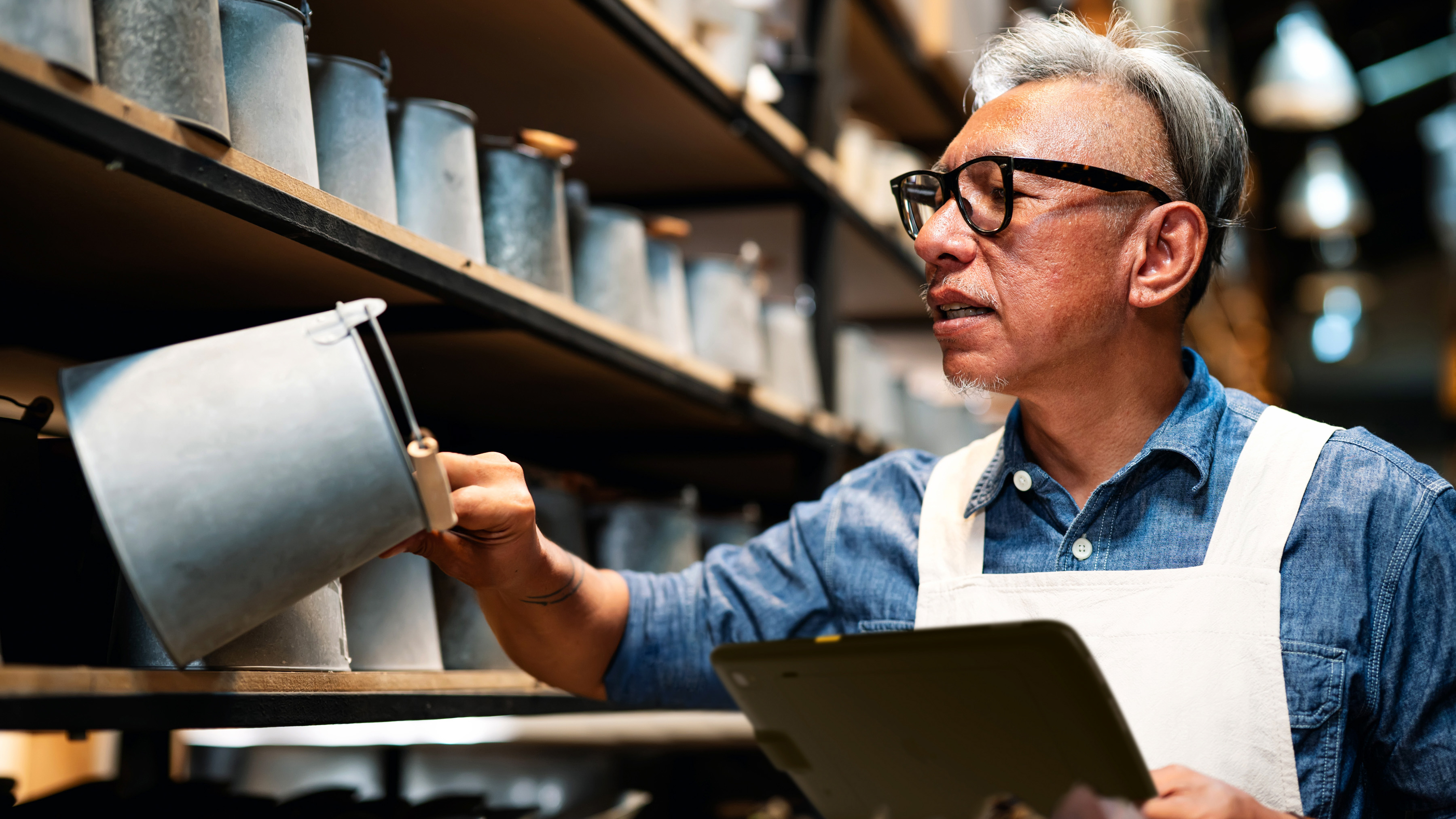 Back of house retail employee using a Zebra tablet to check inventory.  Back of house retail employee using a Zebra tablet to check inventory.