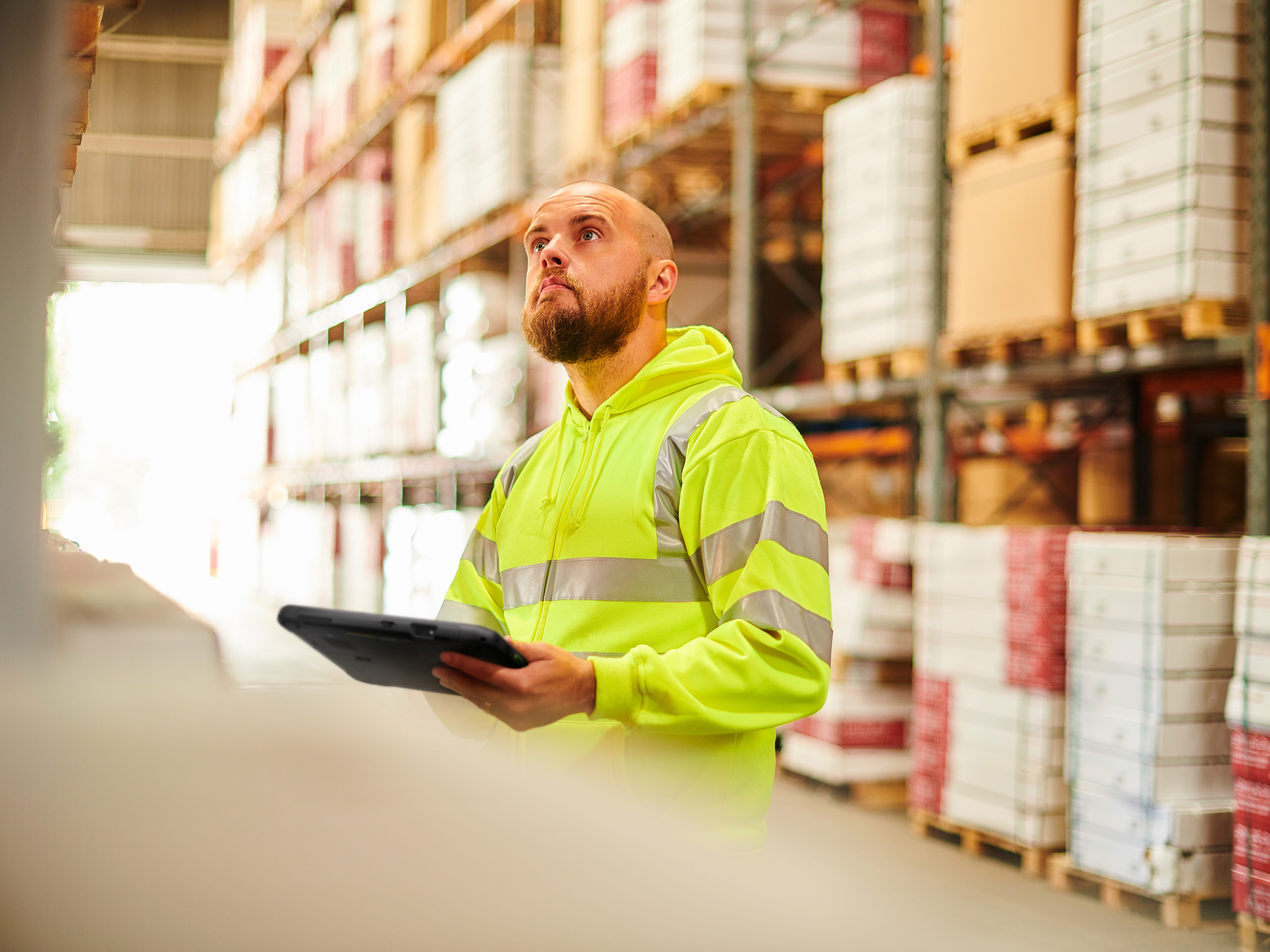Warehouse worker with a Zebra tablet in a store room. Warehouse worker with a Zebra tablet in a store room.
